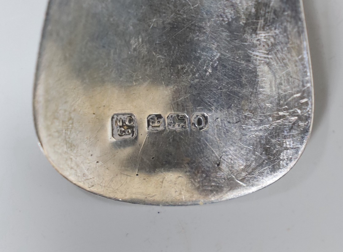Four assorted items of silver flatware, a sterling serving spoon and a George V silver shoe horn (lacking ring), 10.6oz.